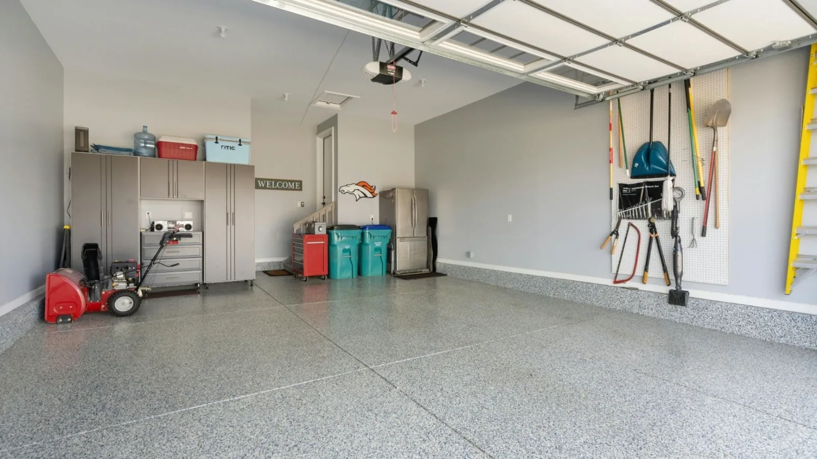 Clean attached garage interior with a ceiling ventilation grille
