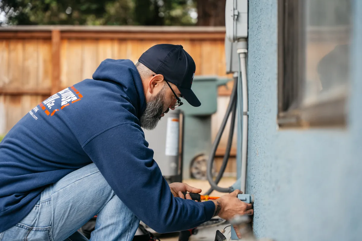 Whole House Fan Co. technician diagnosing airflow and electrical issues at a Fresno home